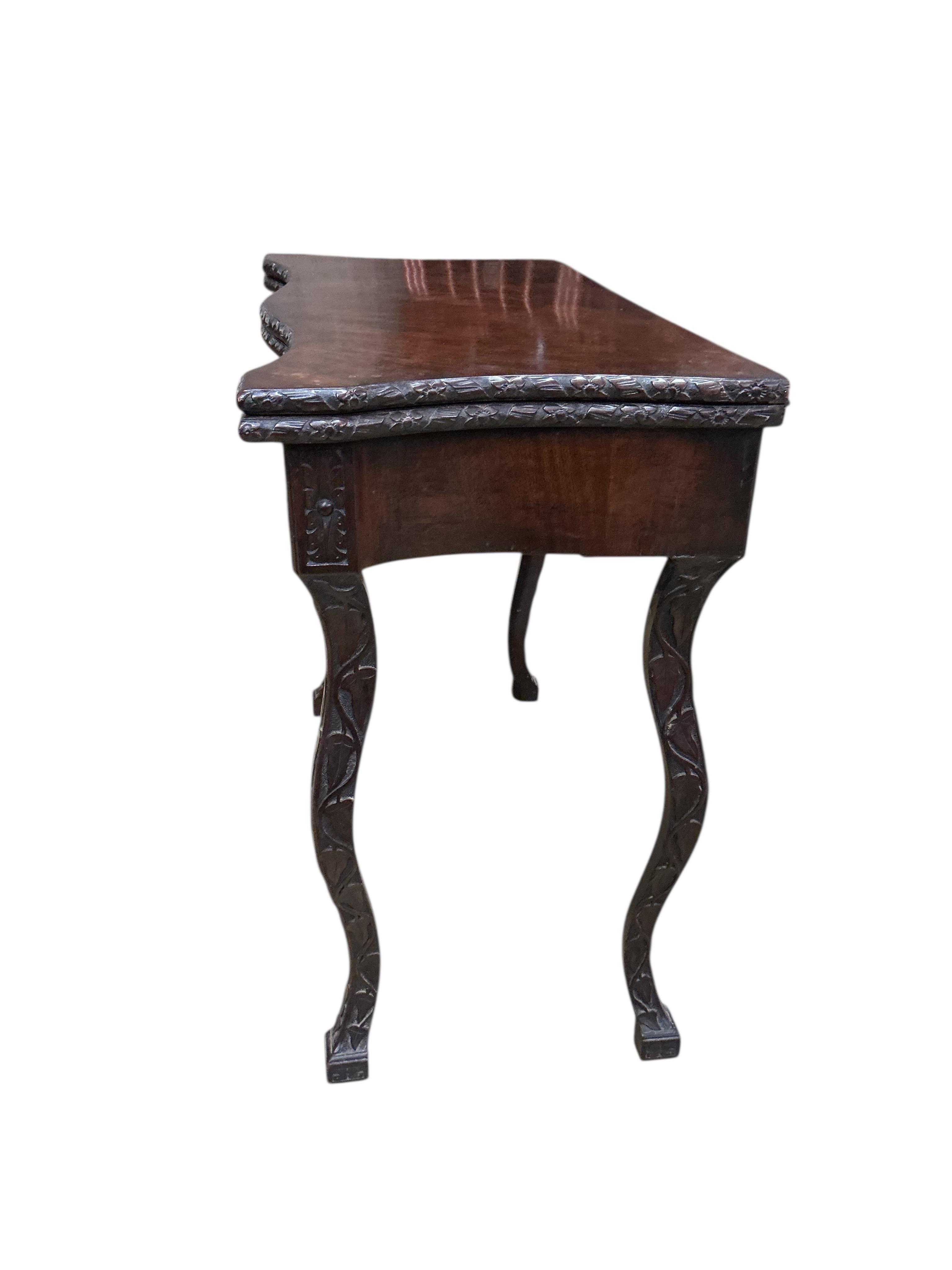 A George II style serpentine mahogany folding card table, width 86cm, depth 43cm, height 73cm
